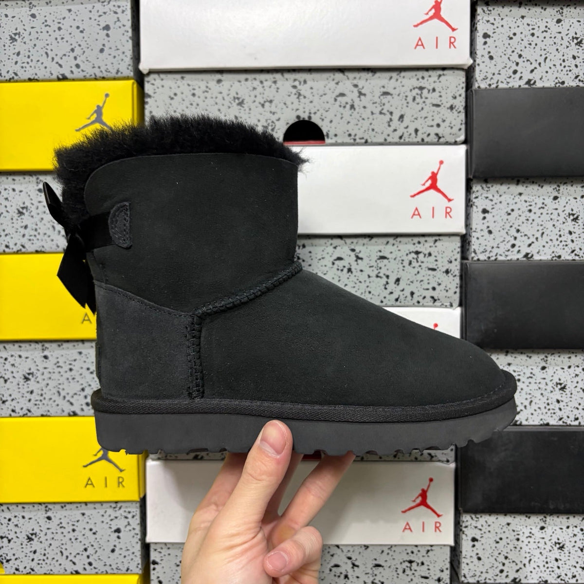 UGG Mini Bailey Bow Ankle Boot – Suede Boot with Tonal Black Shearling Lining, Black Satin Bow & All-Black Lug Sole in Black